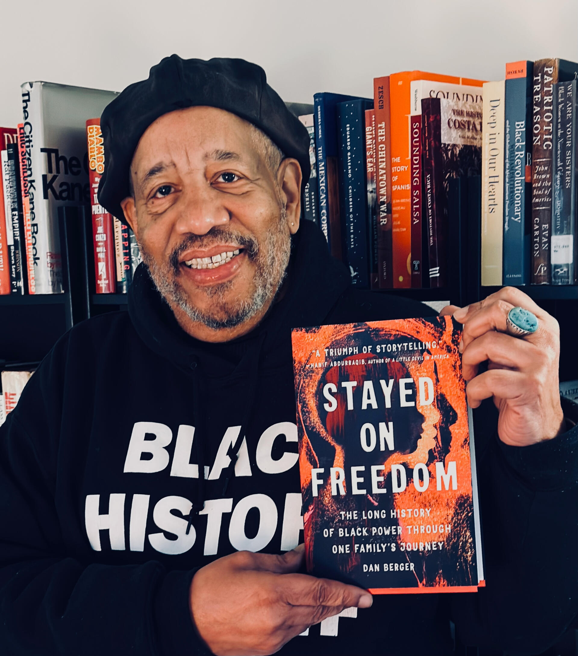 Michael Simmons holding a copy of Stayed on Freedom
